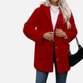 Person wearing a red coat with a plain background